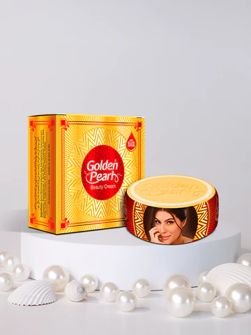 Beauty Cream shown with its yellow and red packaging box and a round tin container featuring a printed portrait of a woman, displayed on a white pedestal with decorative pearls and shells against a light gray background.